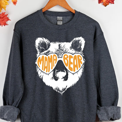 May include: A dark gray sweatshirt with a white bear wearing heart-shaped sunglasses that say "Mama Bear" in orange letters.