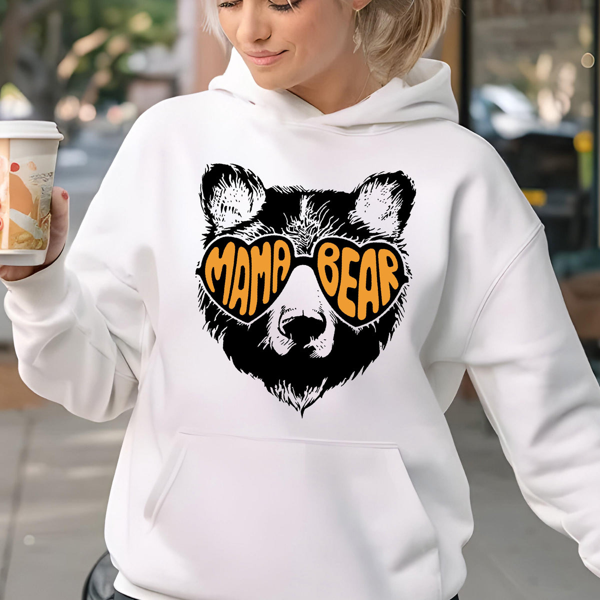 May include: White hoodie with a black bear wearing orange heart-shaped sunglasses that say "Mama Bear".
