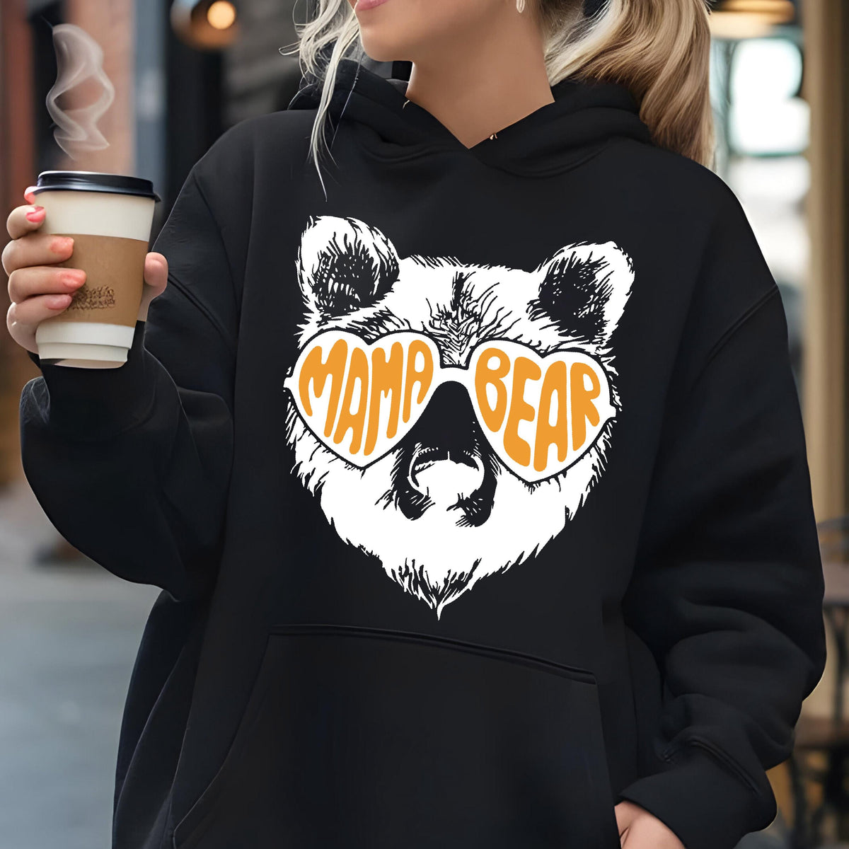 May include: Black hooded sweatshirt with a white bear wearing orange heart-shaped sunglasses that say "Mama Bear".