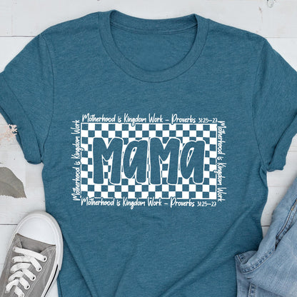 May include: Teal blue t-shirt with a white checkered background and the word "mama" in white outlined letters. The text "Motherhood is Kingdom Work - Proverbs 3:25-27" is repeated on the top and bottom of the checkered background.