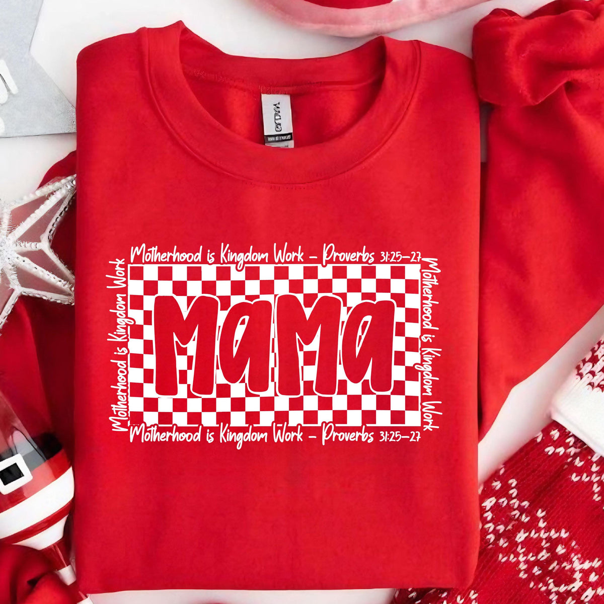 May include: Red sweatshirt with a white checkered background and the word "Mama" in white letters. The text "Motherhood is Kingdom Work - Proverbs 3:25-27" is written above and below the checkered background.