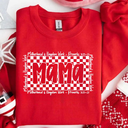 May include: Red sweatshirt with a white checkered background and the word "Mama" in white letters. The text "Motherhood is Kingdom Work - Proverbs 3:25-27" is written above and below the checkered background.