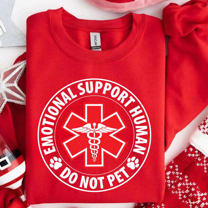 May include: Red sweatshirt with a white circle graphic that says "Emotional Support Human Do Not Pet" with a medical symbol inside the circle.