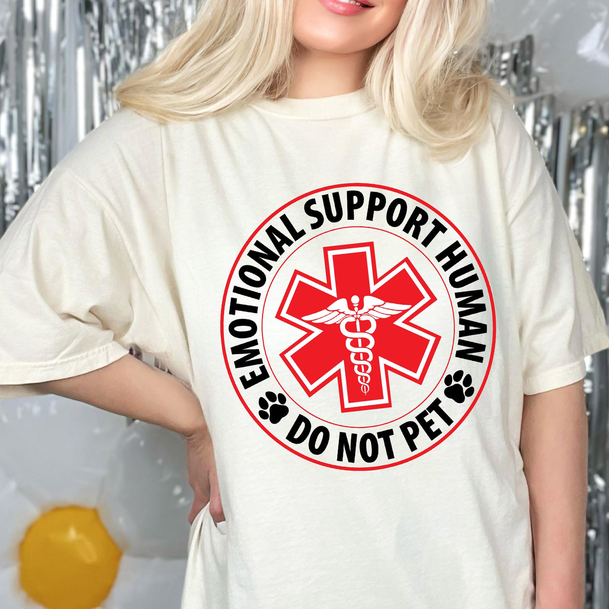 May include: White t-shirt with a red and black circle graphic that says "Emotional Support Human Do Not Pet" with a red medical symbol and a snake inside.