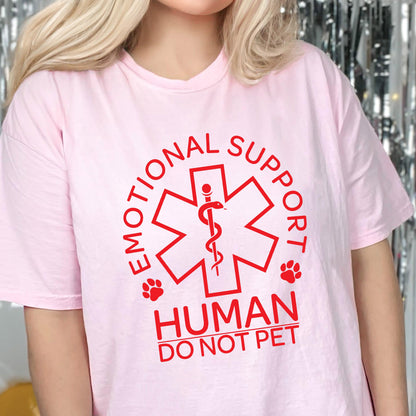 May include: A light pink short-sleeved t-shirt featuring a red graphic of a six-pointed star of life symbol with a snake and staff. The text reads EMOTIONAL SUPPORT HUMAN DO NOT PET, accompanied by two small red paw print icons on the sides.