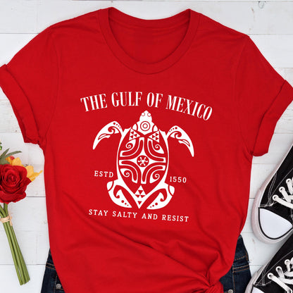 May include: Red t-shirt with a white graphic of a stylized turtle with the text "The Gulf of Mexico Est. 1550 Stay Salty and Resist"