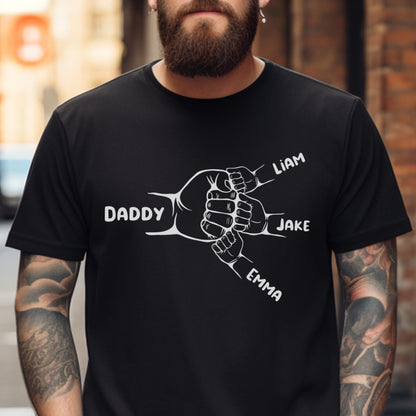 May include: Black t-shirt with a white graphic of four hands clasped together. The hands are labeled "Daddy", "Liam", "Jake", and "Emma".