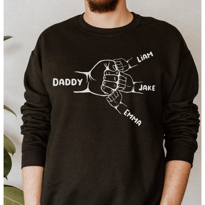 May include: Black sweatshirt with a white graphic of five hands clasped together. The hands are labeled "Daddy", "Liam", "Jake", and "Emma".