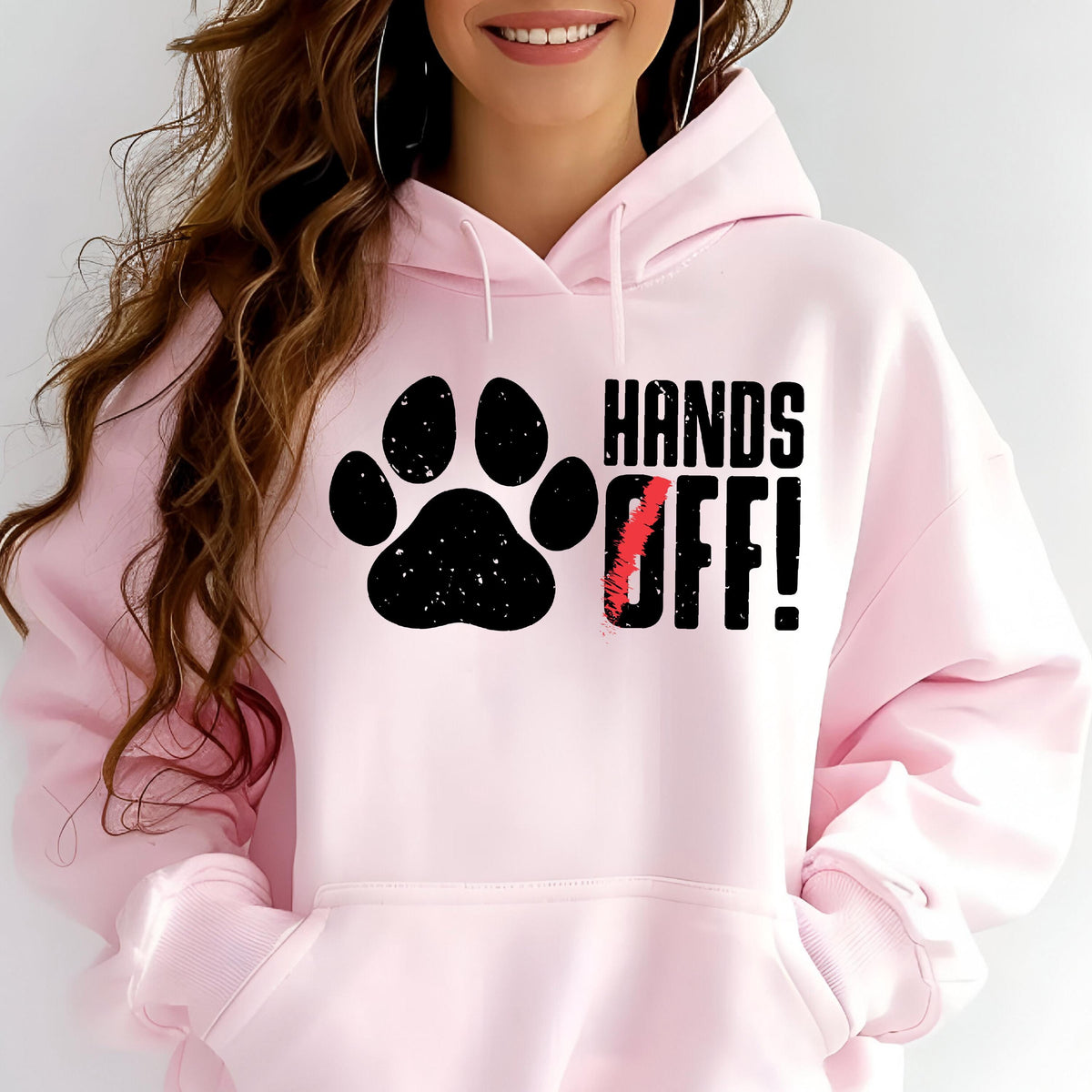 May include: Pink hoodie with a black paw print and the text "HANDS OFF!" in black letters.