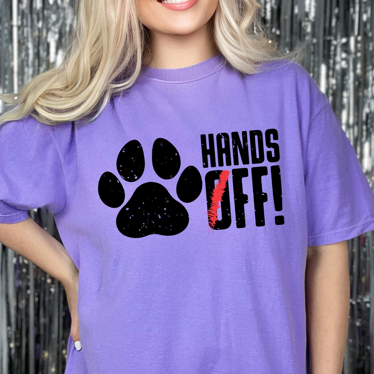 May include: Purple t-shirt with a black paw print and the text "HANDS OFF!" in black.