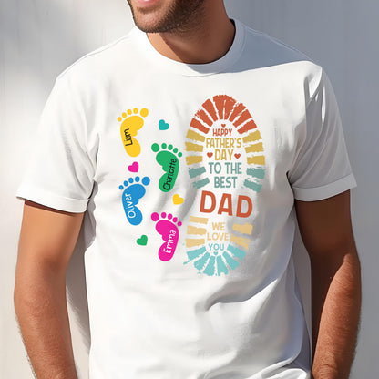 May include: White t-shirt with a colorful design for Father's Day. The design includes footprints in yellow, green, blue, and pink, with names, and a large footprint shape with the text "Happy Father's Day to the Best Dad."