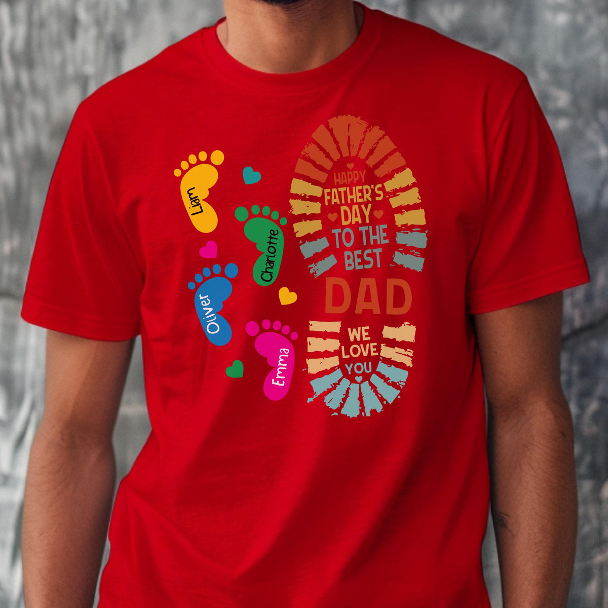 May include: Red t-shirt with a colorful design for Father's Day. The design includes footprints in yellow, green, blue, and pink, each with a name. A large footprint shape contains the text "Happy Father's Day to the Best Dad, We Love You."