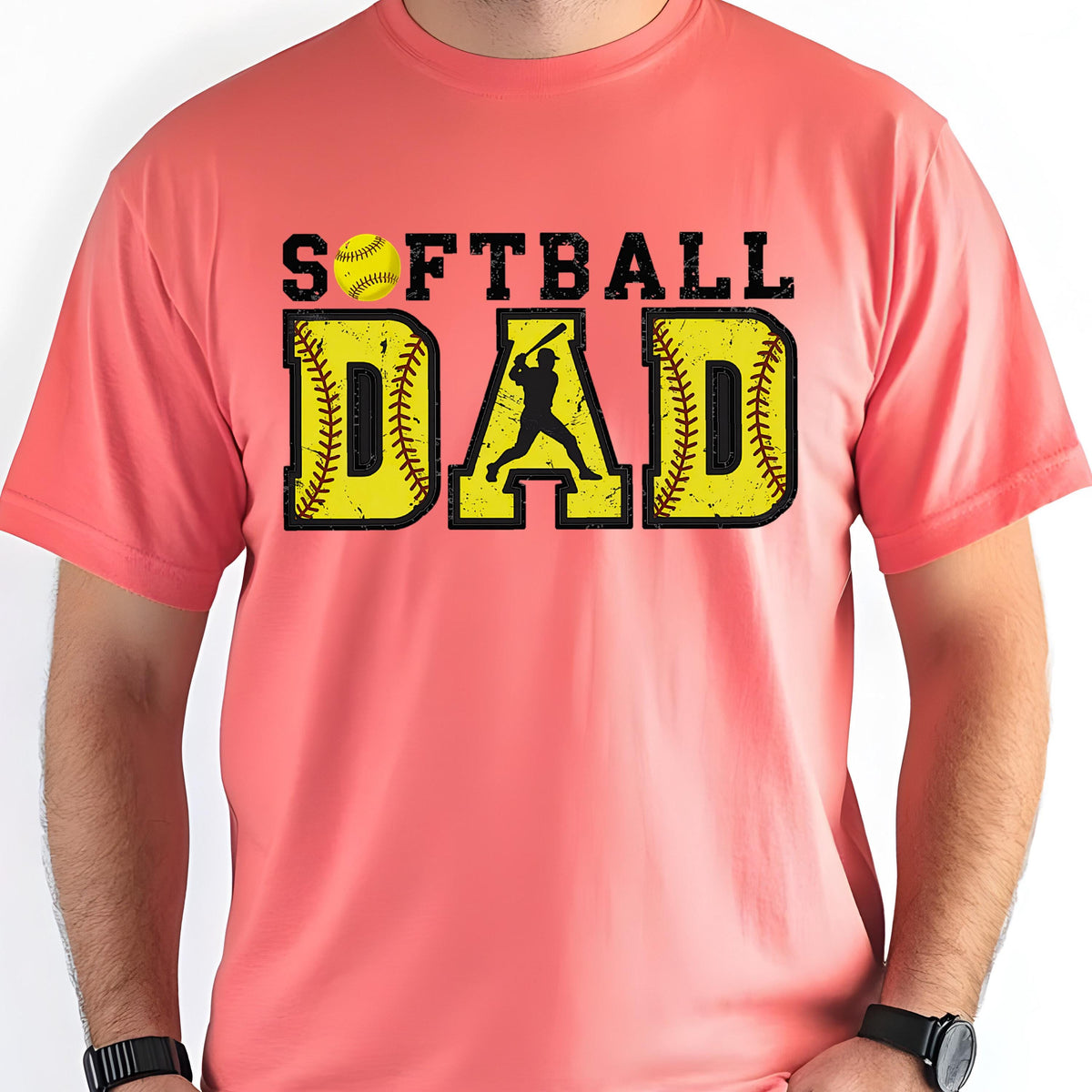 May include: A coral pink t-shirt with the text "Softball Dad" in black and yellow letters. A softball player silhouette is in the middle of the word "DAD".