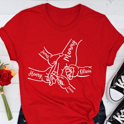 May include: A red t-shirt featuring a white graphic of hands intertwined, with the names "James", "Henry", "Olivia", "Emma", and "Mammy" written on the design. The shirt is made of a soft material.