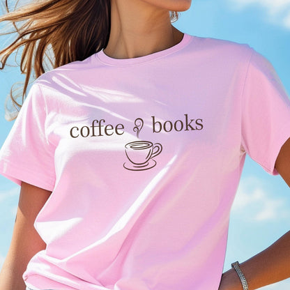 May include: A light pink t-shirt with the words "coffee & books" printed in brown. A coffee cup graphic is between the words. The shirt is short-sleeved and made of a soft material.