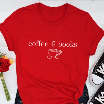 May include: A red t-shirt with white text and a graphic of a coffee cup. The text reads "coffee & books". The shirt is folded, with a pair of black sneakers visible in the background.