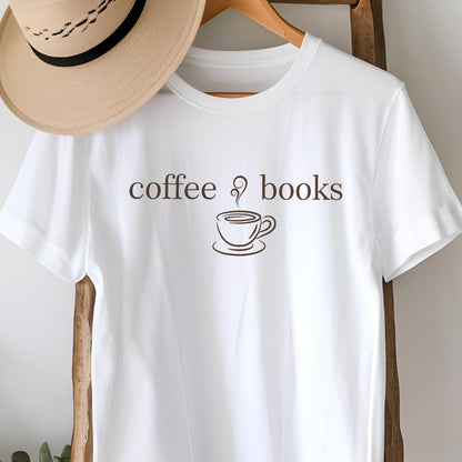 May include: White t-shirt with the words "coffee & books" in brown lettering, along with a coffee cup illustration. A tan hat hangs on a wooden hanger above the shirt.