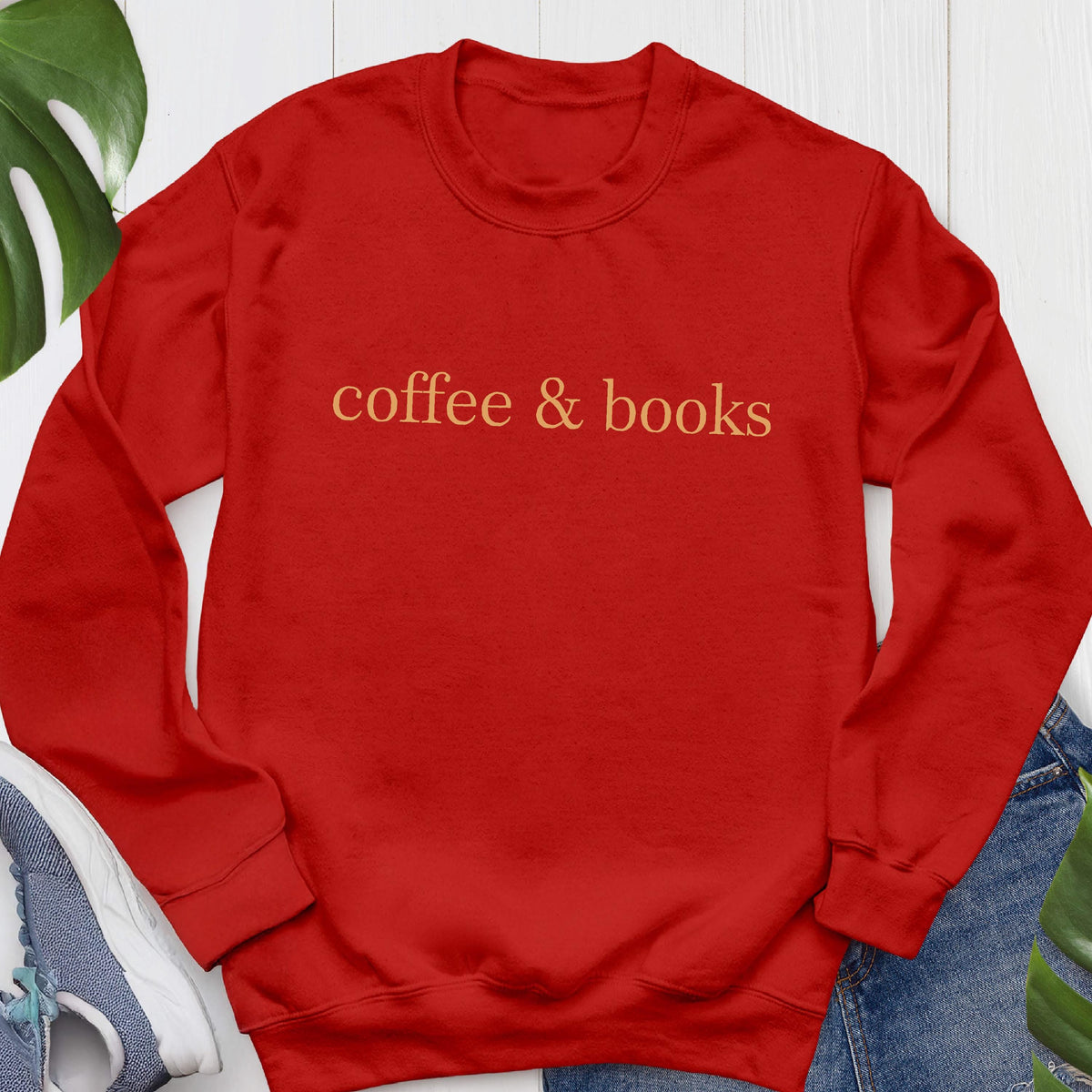 May include: Red long-sleeved sweatshirt with the text "coffee & books" in orange.