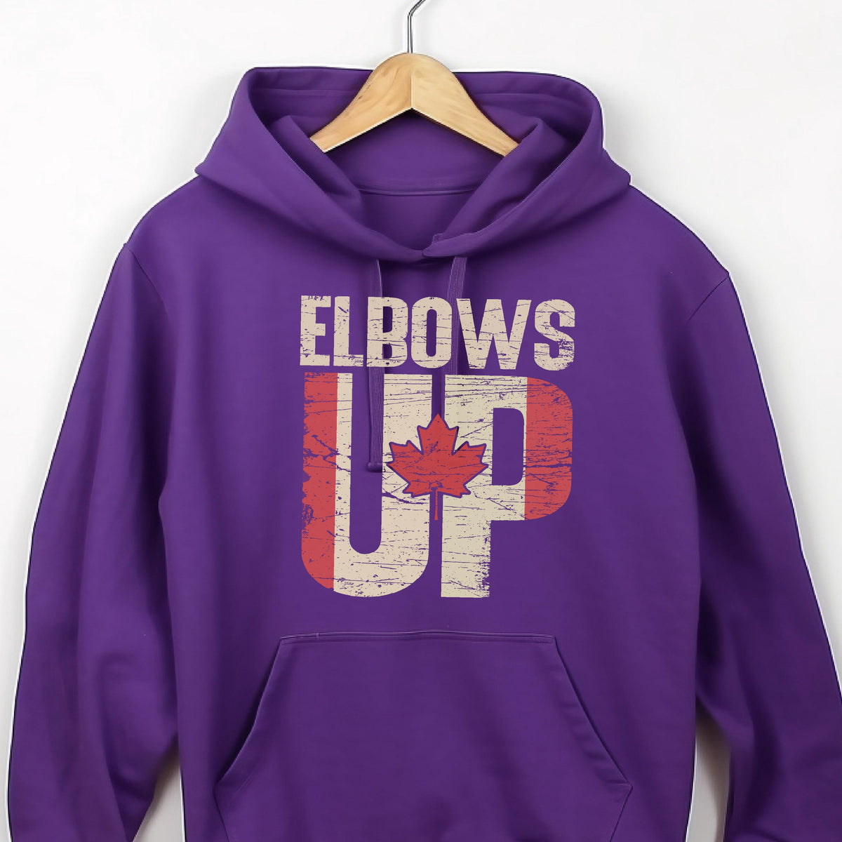 May include: Purple hoodie with a distressed Canadian flag design and the text "Elbows Up" in white.