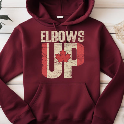May include: A maroon hoodie with a distressed Canadian flag design and the text "Elbows Up" printed on the front.