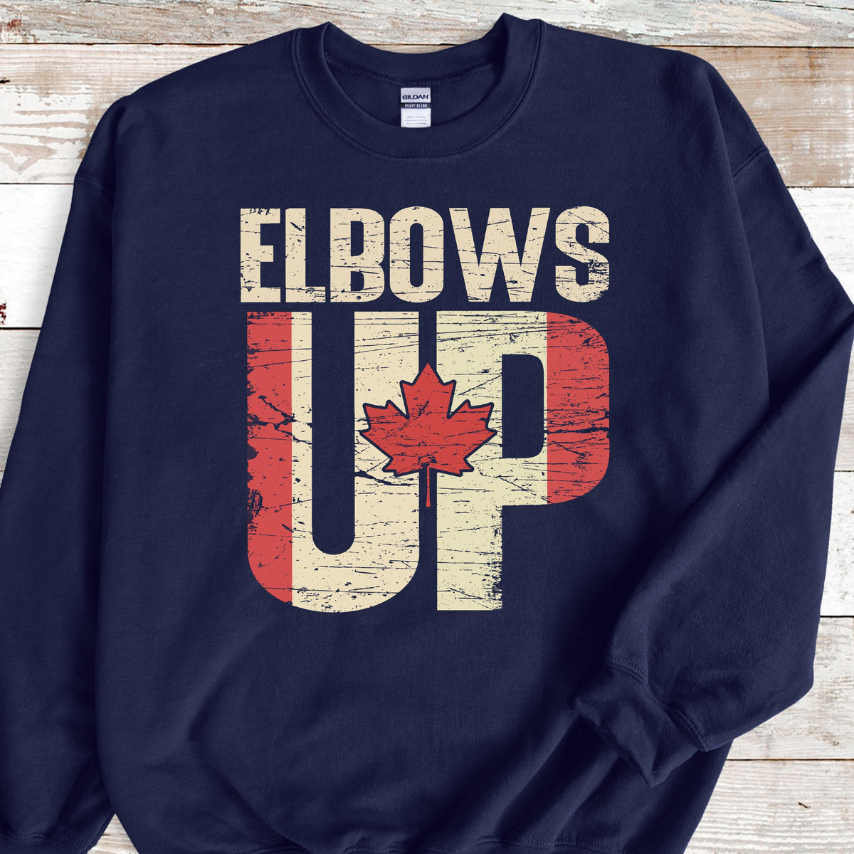 May include: Navy blue sweatshirt with the text "Elbows Up" in white letters. The "Up" is stylized with a Canadian flag design.