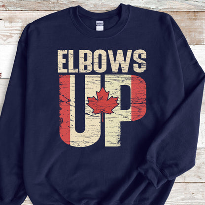 May include: Navy blue sweatshirt with the text "Elbows Up" in white letters. The "Up" is stylized with a Canadian flag design.