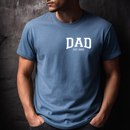 May include: A blue t-shirt with white text that reads "DAD EST. 2025".