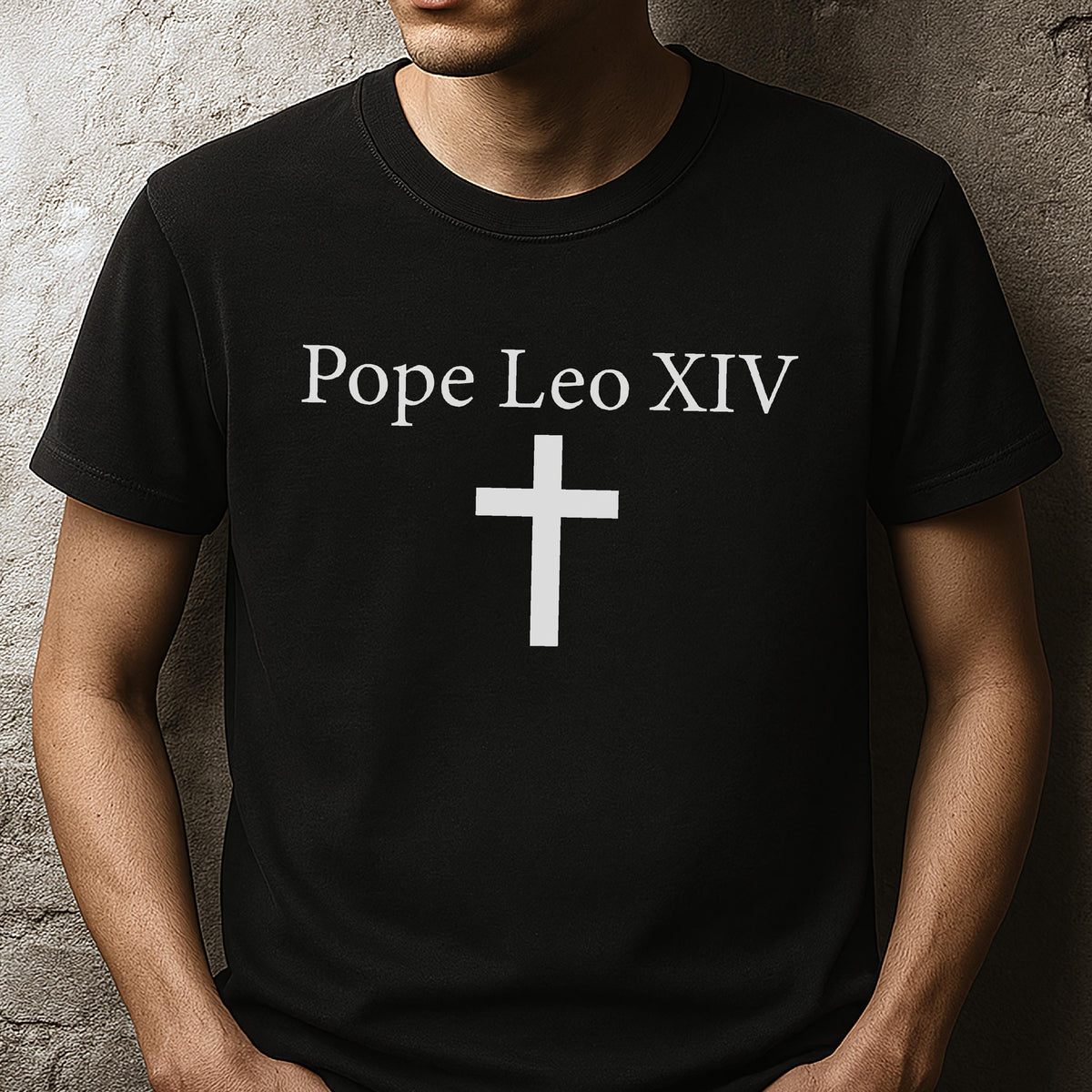 May include: Black t-shirt with the text "Pope Leo XIV" above a white cross. The shirt is a solid black color and has a crew neck.