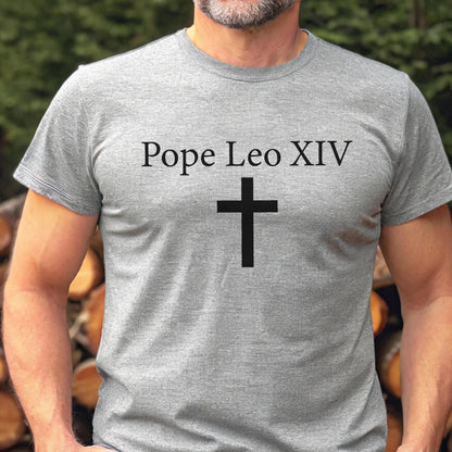 May include: A gray t-shirt with the text "Pope Leo XIV" above a black cross. The shirt is short-sleeved and made of a soft material.