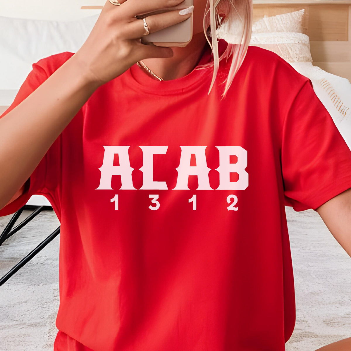 May include: A bright red short-sleeved t-shirt featuring the white text ACAB in a bold, blocky font centered on the chest. Below the letters, the numbers 1 3 1 2 are printed in a matching white, clean, sans-serif typeface across the front.