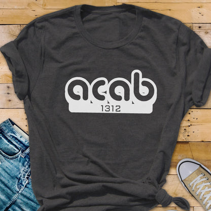 May include: A dark gray t-shirt with a white graphic that says "ACAB" with the number "1312" underneath.