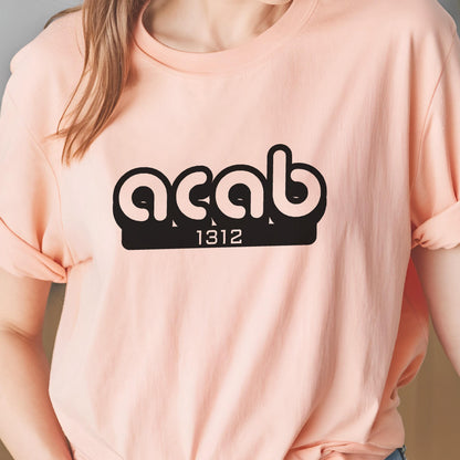 May include: A pink t-shirt with a black graphic that says "ACAB 1312".