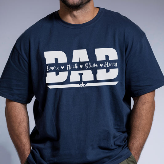 May include: Navy blue t-shirt with the word "DAD" in large white block letters. Below the word "DAD" are the names Emma, Noah, Olivia, and Henry, each separated by a heart symbol. A white star is centered below the names.