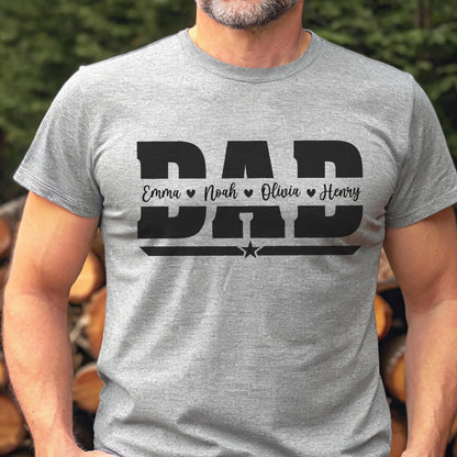 May include: A gray t-shirt with the word "DAD" in bold black letters. Below the word "DAD" are the names Emma, Noah, Olivia, and Henry, each with a heart symbol. A star is below the names.