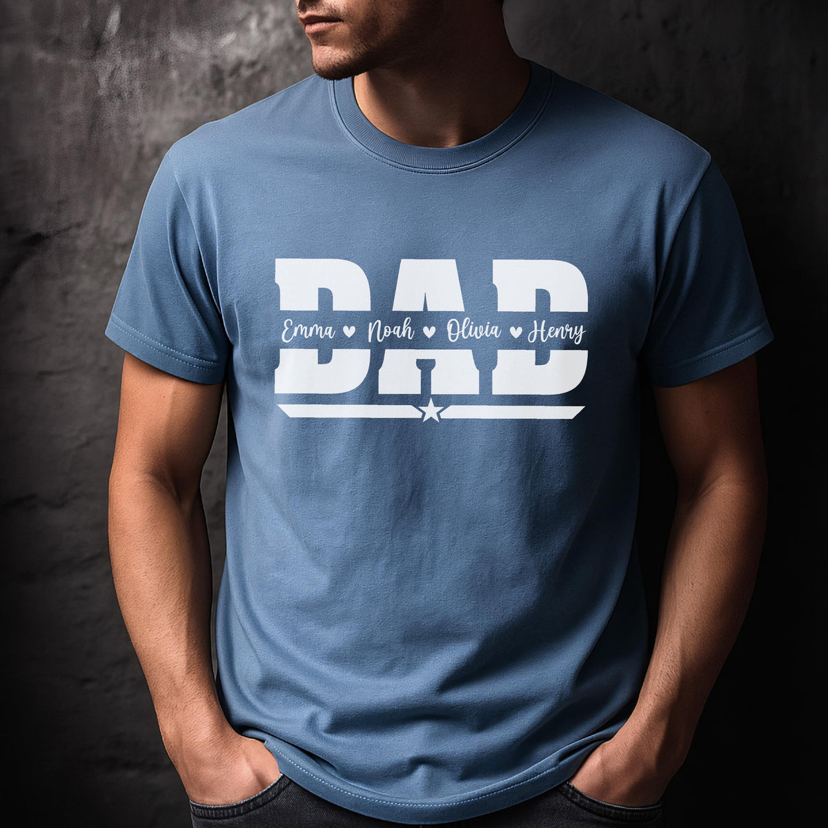 May include: A light blue t-shirt with the word "DAD" in large white block letters. Below the word "DAD" are the names Emma, Noah, Olivia, and Henry. A white star is below the names.