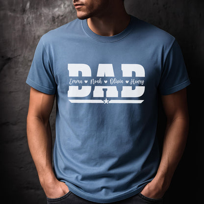 May include: A light blue t-shirt with the word "DAD" in large white block letters. Below the word "DAD" are the names Emma, Noah, Olivia, and Henry. A white star is below the names.