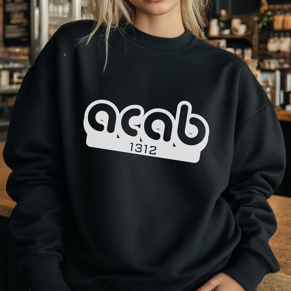 May include: Black sweatshirt with white text that reads "acab 1312".