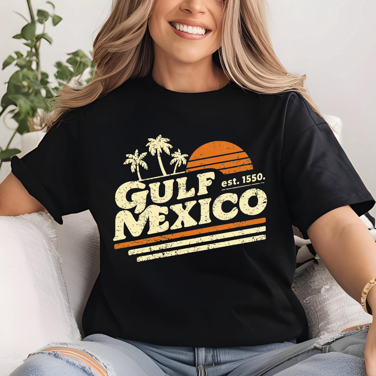 May include: Black t-shirt with a retro design featuring the words "GULF MEXICO" in a distressed, off-white font, with palm trees and a setting sun graphic. The text "est. 1550" is also included.
