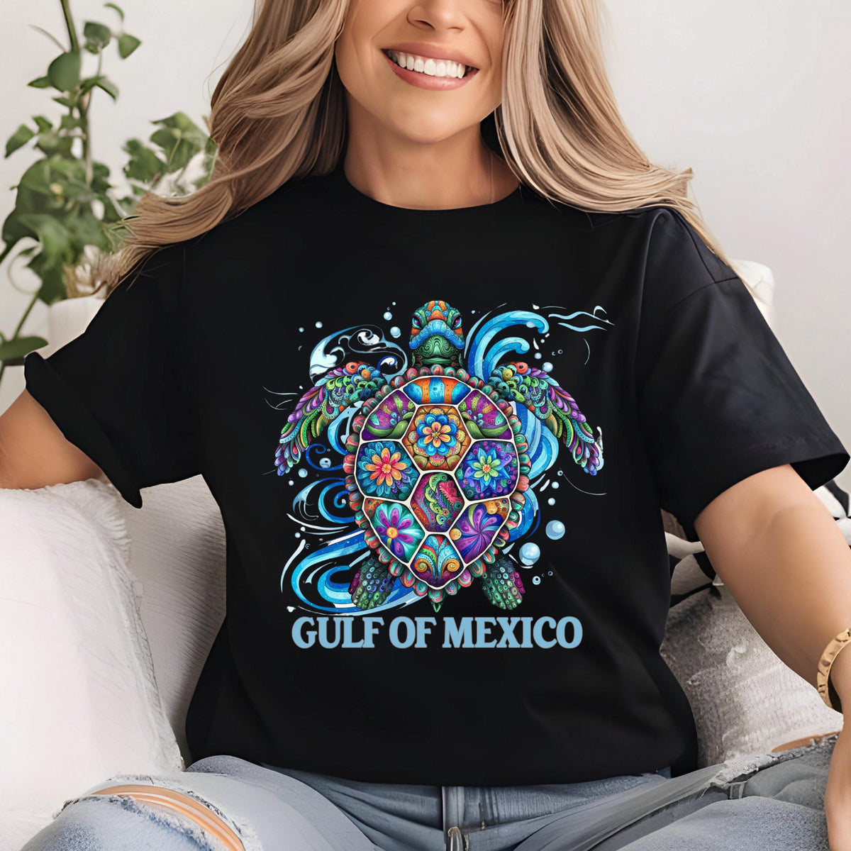 May include: Black t-shirt with a colorful, floral patterned sea turtle design and the text "GULF OF MEXICO" in blue.