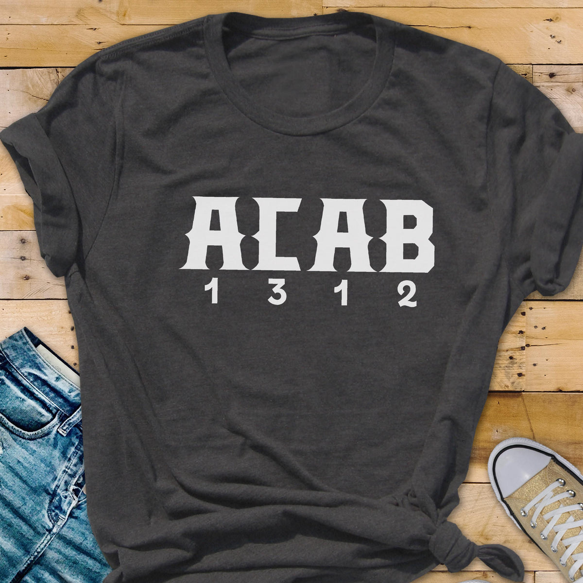 May include: A dark gray t-shirt with the text "ACAB 1312" printed in white.