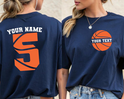 May include: A navy blue t-shirt featuring a large orange number five on the back with the text YOUR NAME above it. The front of the shirt displays an orange basketball graphic on the left chest area with the text YOUR TEXT printed across it.