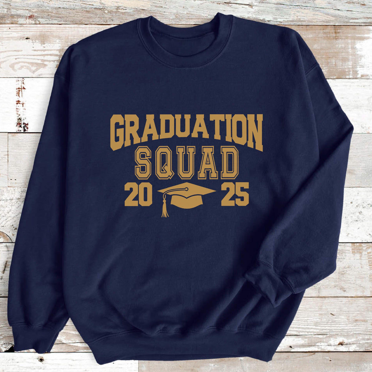 May include: Navy blue sweatshirt with the words "GRADUATION SQUAD" in gold lettering. Below the text are the numbers "20" and "25" with a graduation cap in between. A comfortable crew neck sweatshirt for graduation.