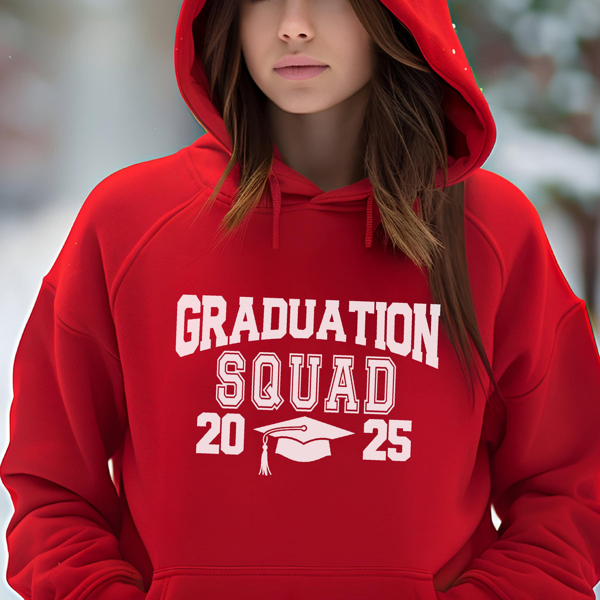 May include: A red hooded sweatshirt with the words "GRADUATION SQUAD 2025" in white block letters. A white graduation cap graphic is centered below the word "SQUAD". The sweatshirt has a drawstring hood and a front pocket.