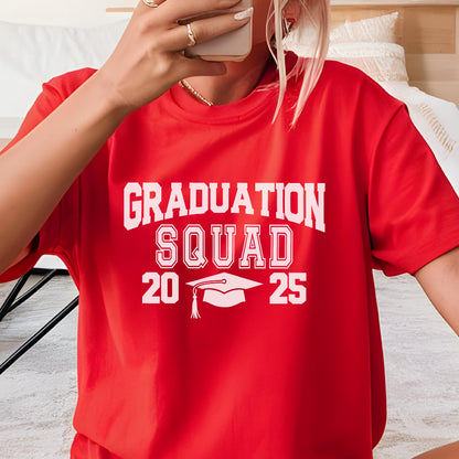 May include: A red t-shirt with the words "GRADUATION SQUAD 2025" in white block letters. A graduation cap graphic is centered below the text. The shirt is short-sleeved.