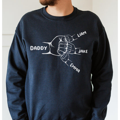 May include: Navy blue sweatshirt with a white graphic of four hands clasped together, each hand labeled with a name: Daddy, Liam, Jake, and Emma.