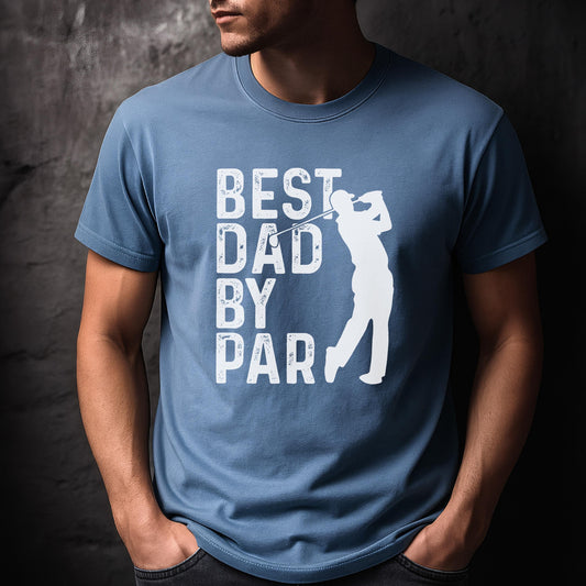 May include: A dusty blue short-sleeved t-shirt featuring a white graphic print. The design includes the text "BEST DAD BY PAR" in a distressed font, accompanied by a white silhouette of a golfer mid-swing with a golf club.