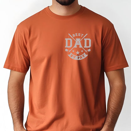 May include: Rust-colored t-shirt with a gray graphic on the chest. The graphic reads "BEST DAD BY PAY" with crossed golf clubs and stars. The shirt has short sleeves and a crew neck.