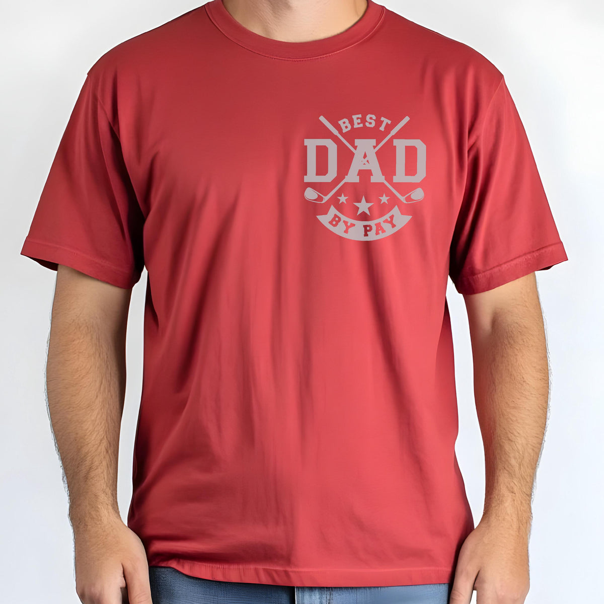 May include: A red t-shirt with the text "BEST DAD BY PAY" in gray. The design includes crossed golf clubs and stars. The shirt is short-sleeved and made of a smooth material.