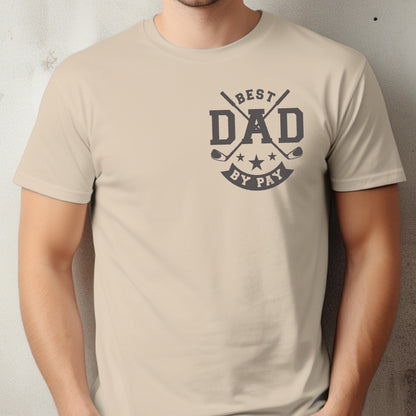 May include: A beige t-shirt with a graphic that reads "BEST DAD BY PAY." The design includes crossed golf clubs, stars, and the word "DAD" in bold letters. The shirt is made of a soft material.
