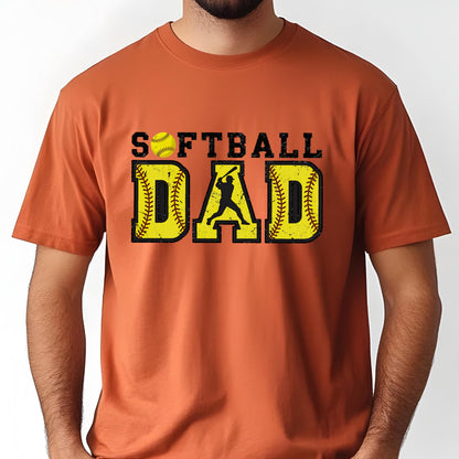 May include: Orange t-shirt with a distressed graphic design that says "Softball Dad" with a softball and a silhouette of a player hitting a ball.